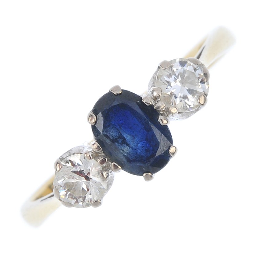 An 18ct gold sapphire and diamond three-stone ring. The (1 of 3)