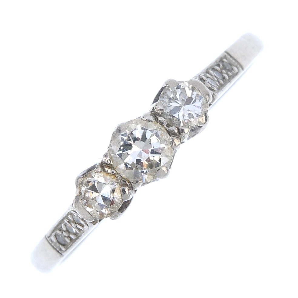 A mid 20th century platinum diamond three-stone ring. (1 of 3)