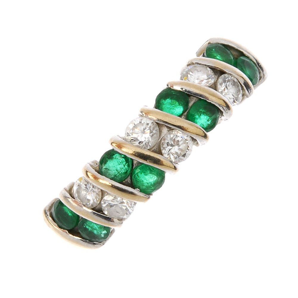 An 18ct gold emerald and diamond ring. Designed as a (1 of 3)