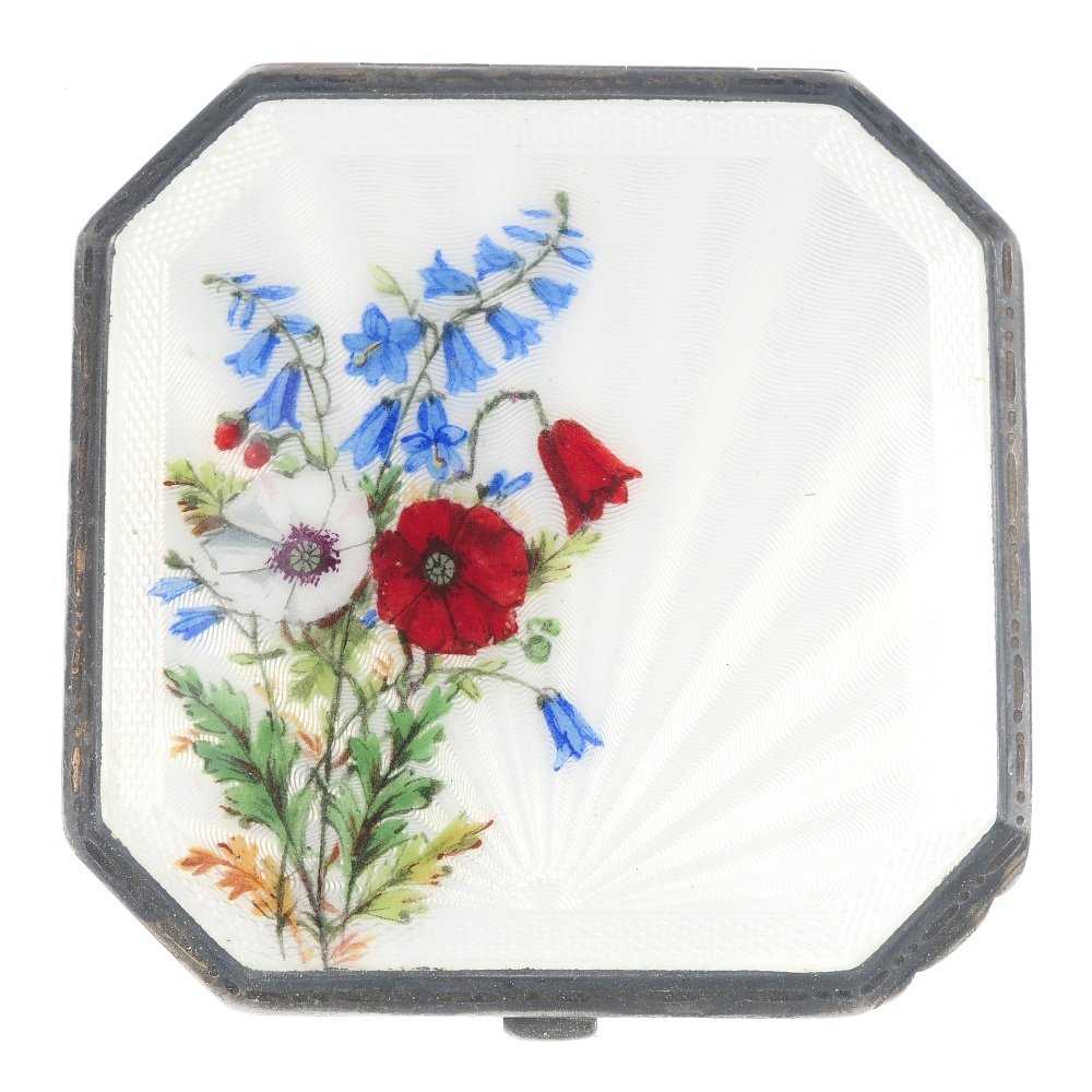 A 1930s silver enamel compact. Designed as a square: A 1930s silver enamel compact. Designed as a square shape compact with chamfered corners, the lid with white guilloche enamel in sunray design with hand-painted wild flowers, opening to reveal a mirro