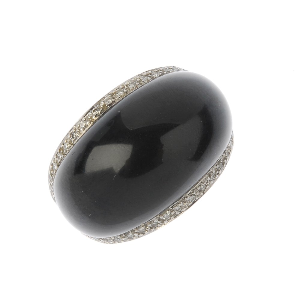 STEPHEN WEBSTER - an onyx and diamond dress ring. The: STEPHEN WEBSTER - an onyx and diamond dress ring. The oval onyx cabochon, within a brilliant-cut diamond surround, to the openwork shoulders and shaped band. Maker's mark for Stephen Webster. Estimate