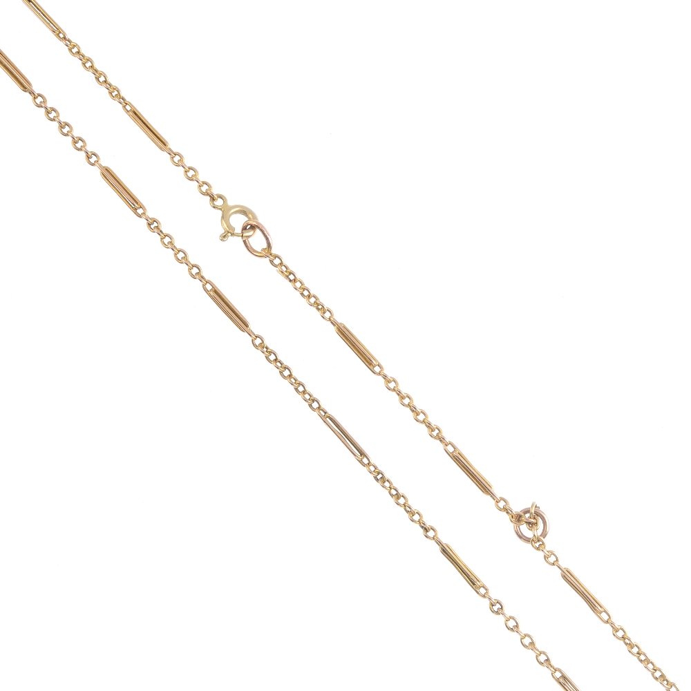 A late Victorian 15ct gold chain. The trombone and (1 of 2)