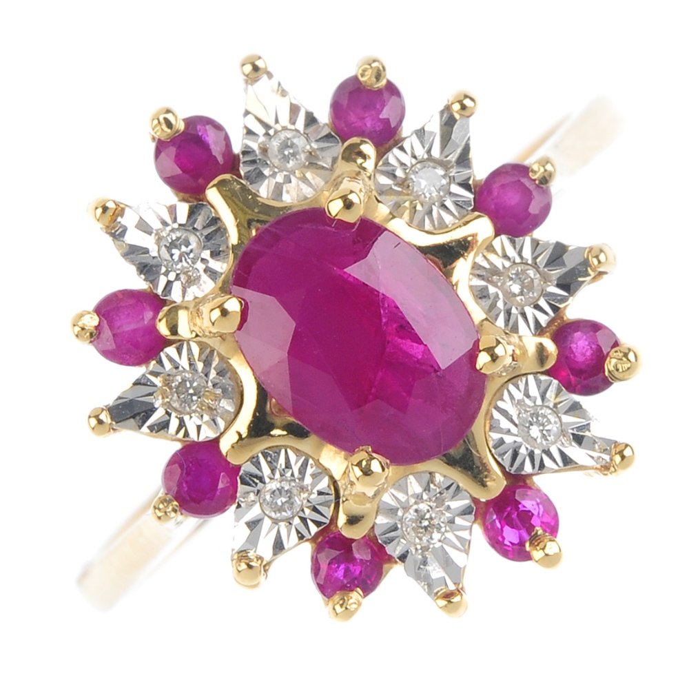 A ruby and diamond cluster ring. The oval-shape ruby, (1 of 3)