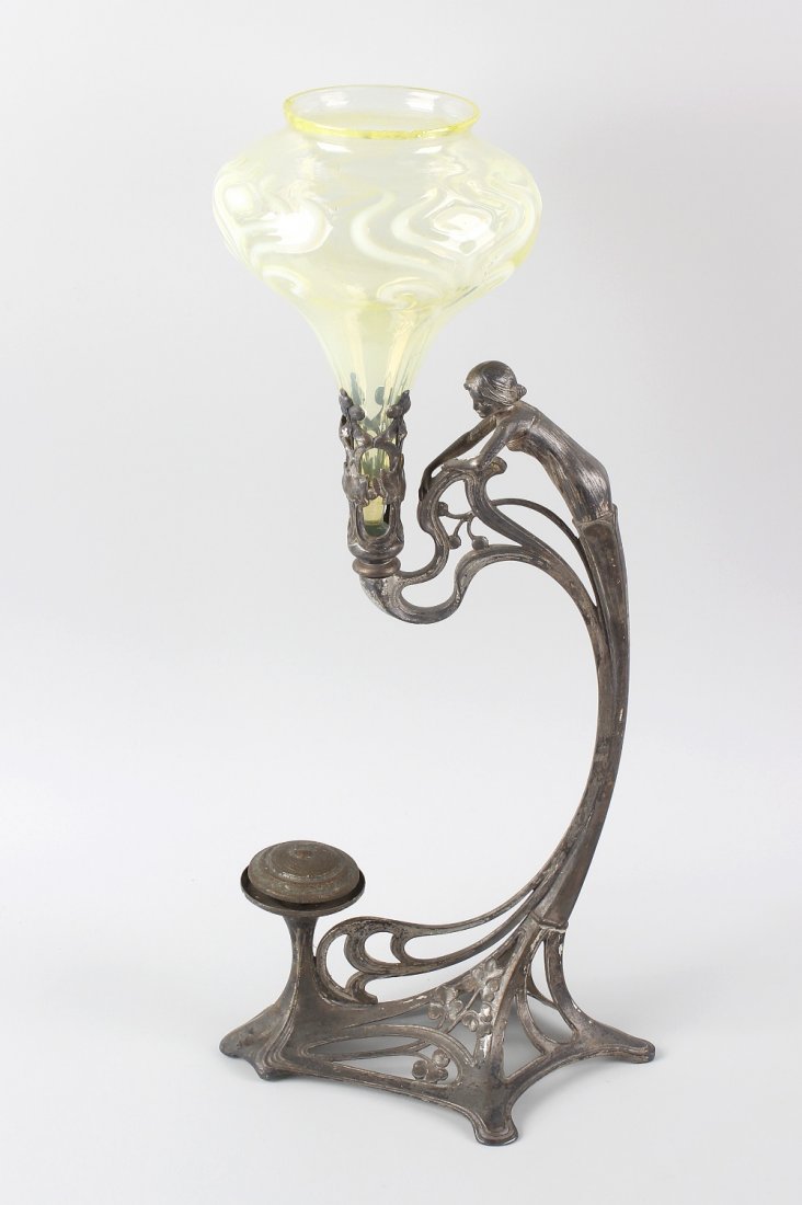 An Art Nouveau pewter epergne, of WMF style, with a: An Art Nouveau pewter epergne, of WMF style, with a fluted yellow glass bowl to the foliate socle supported by a female figure capped scrolling stem leading to the spreading base having further screw-