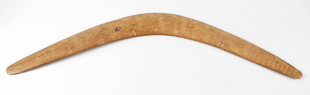 A vintage Australian aboriginal boomerang, of: A vintage Australian aboriginal boomerang, of traditional shape and hand carved form, with 'scratched' decoration, 29 (73.75cm) wide. Surface wear, scratches and marks.Signs of a knot of disease in th