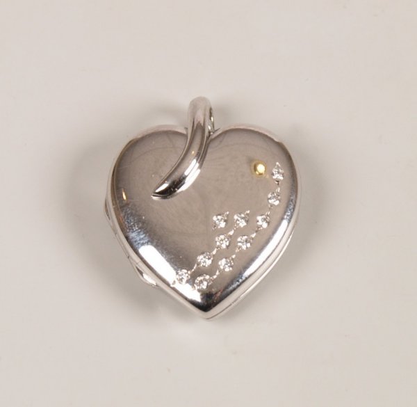 "18ct white gold heart shape locket with a scatter: "18ct white gold heart shape locket with a scattered round brilliant diamond set front design. Length - 2.5cms, Width - 1.9cms.
