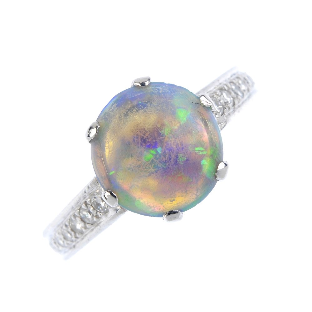 A platinum opal and diamond ring. The opal cabochon, (1 of 3)