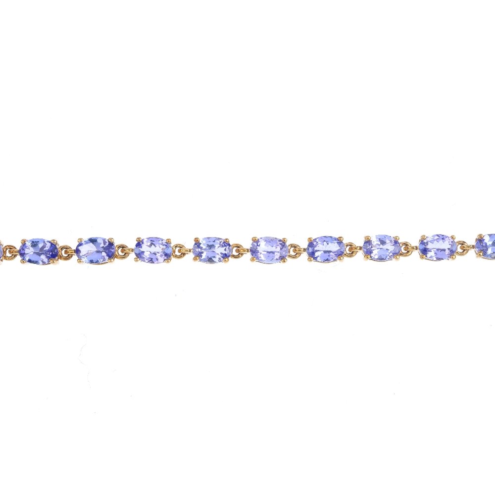 A 9ct gold tanzanite bracelet. Designed as a series of (1 of 3)