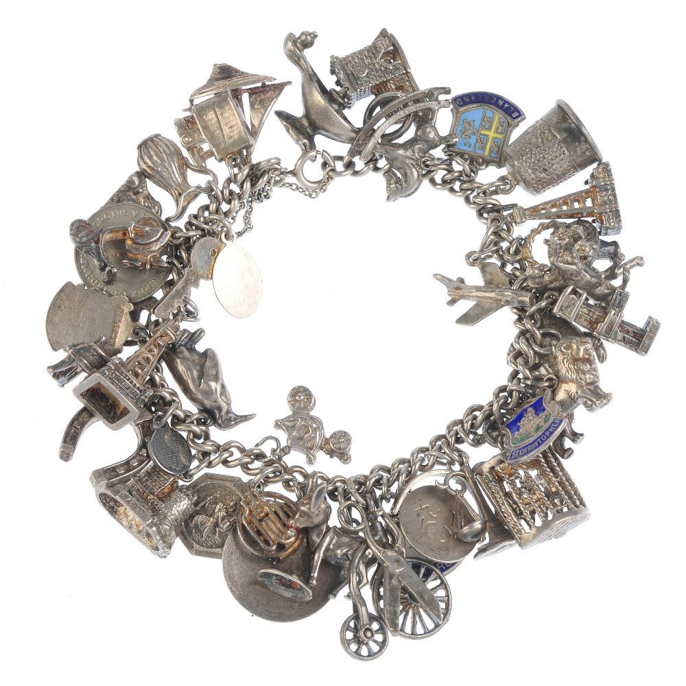 Two charm bracelets. The two curb-link bracelets,: Two charm bracelets. The two curb-link bracelets, suspending a total of fifty-three charms, to include a Blackpool tower charm and several enamel place shield charms, including one for Morecambe. Leng
