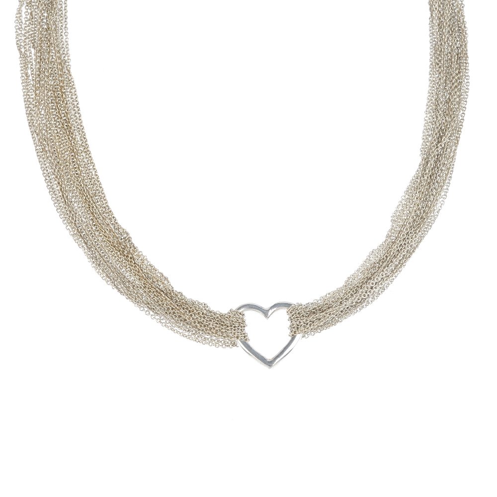TIFFANY & CO. - a necklace. Each side with ten chains: TIFFANY & CO. - a necklace. Each side with ten chains looped through the central heart shape to the T-bar clasp. Signed Tiffany & Co. Elsa Perretti. Length 41cms. Weight 36.6gms. With maker's case. Th