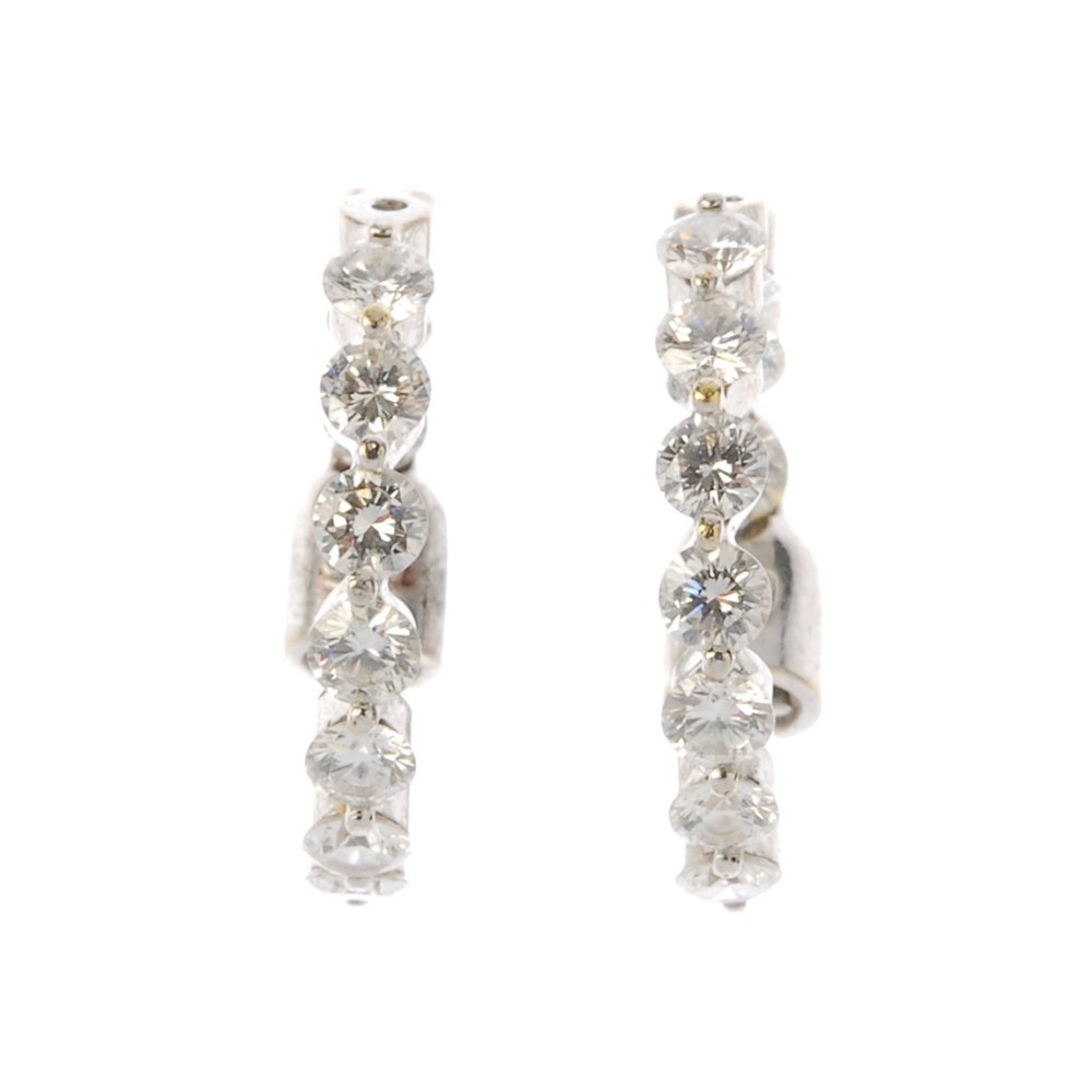 A pair of diamond ear-hoops. Each designed as a (1 of 1)