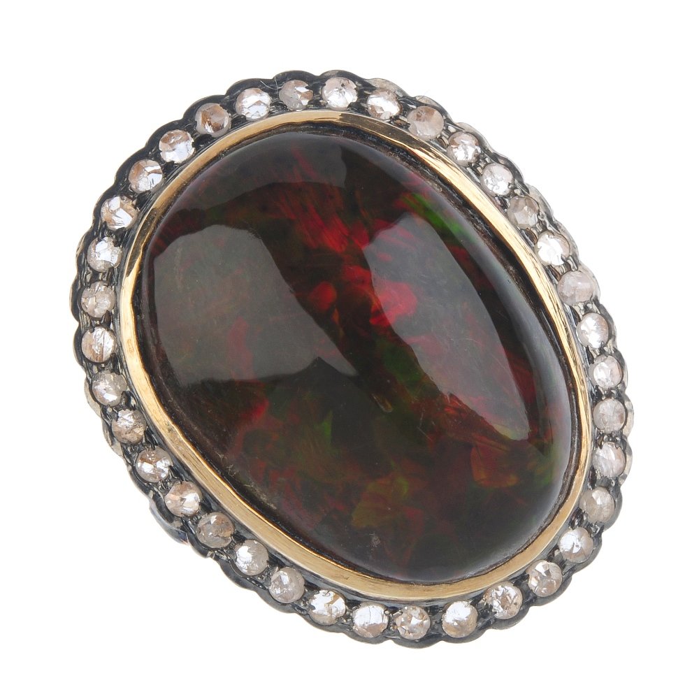 An opal and diamond cluster ring. The oval-shape opal, (1 of 3)