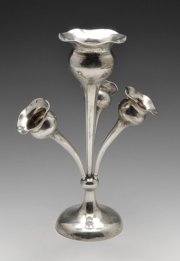An Edwardian silver epergne, having a wavy rim above: An Edwardian silver epergne, having a wavy rim above the bulbous and tapering central vase supporting three further smaller vases to the knopped and spreading circular foot. Hallmarked to fittings Lon