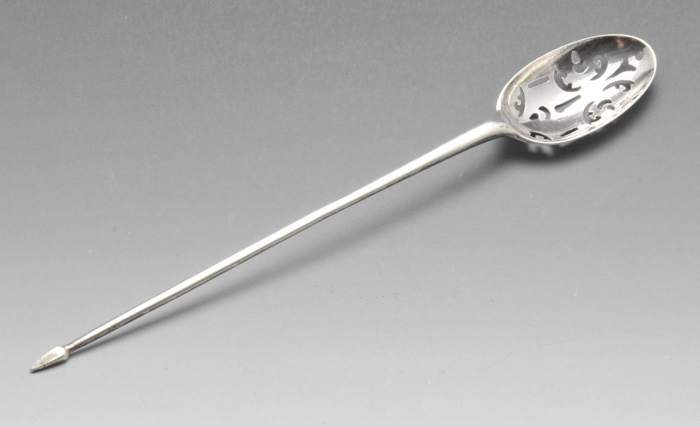 An eighteenth century silver mote spoon of typical form: An eighteenth century silver mote spoon of typical form with scroll pierced bowl and tapered stem with pointed terminal. Lion passant only alongside makerâ€™s mark possibly a crowned L.I. Length