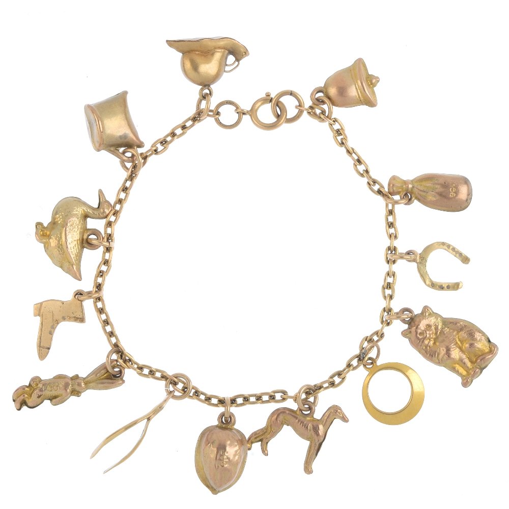 A mid 20th century 9ct gold charm bracelet. The (1 of 3)