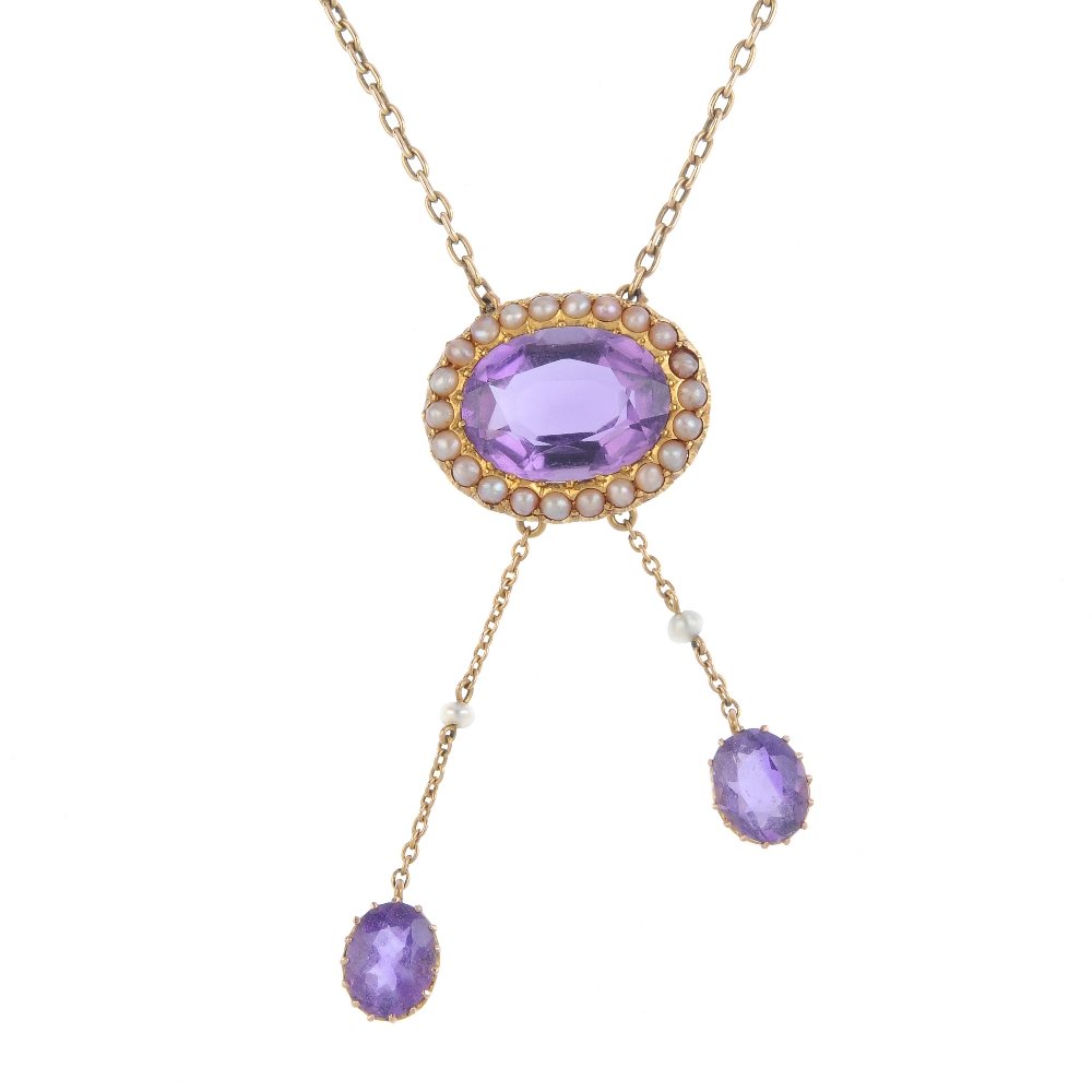 An amethyst and seed pearl necklace. The oval amethyst (1 of 3)