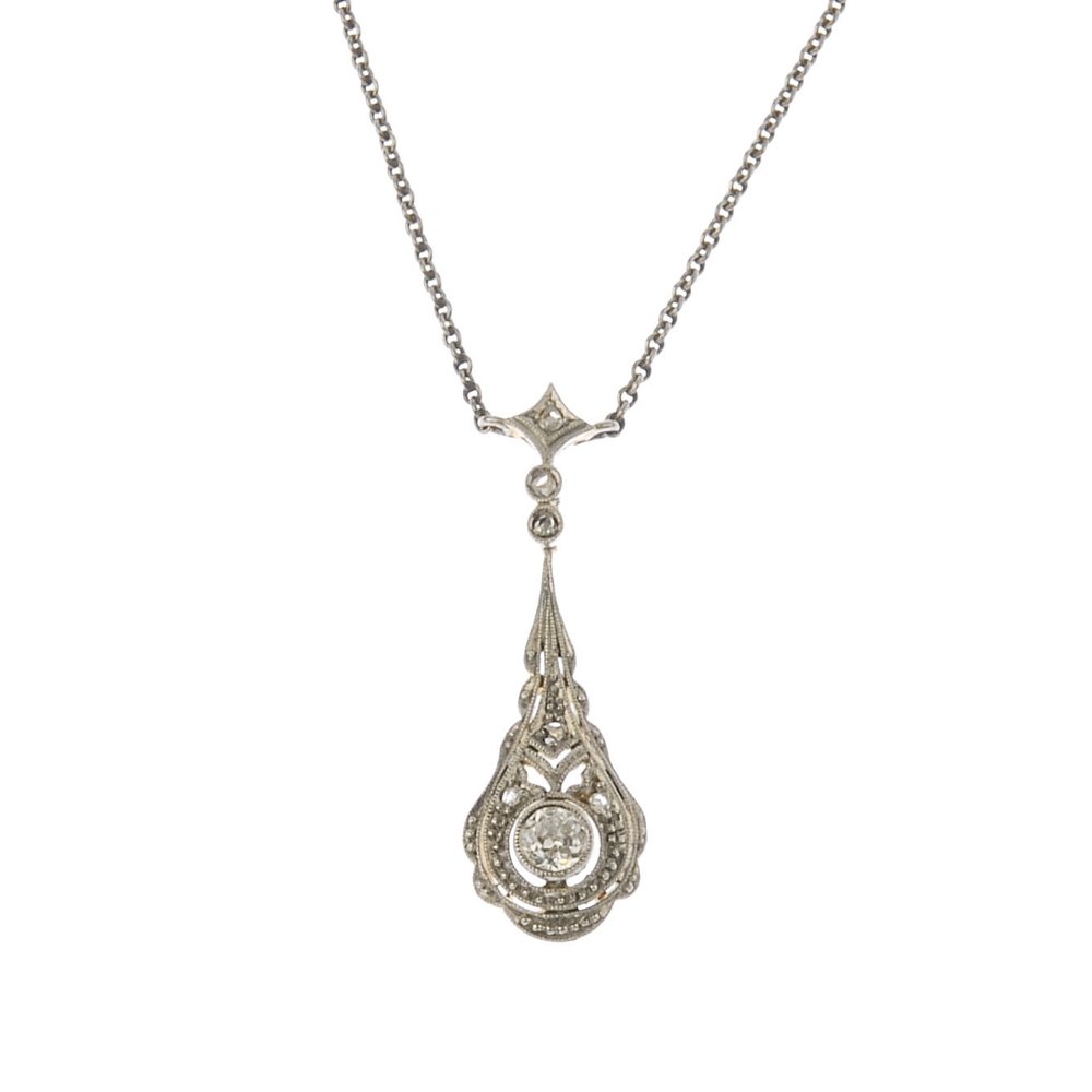 An early 20th century gold diamond pendant. The (1 of 3)