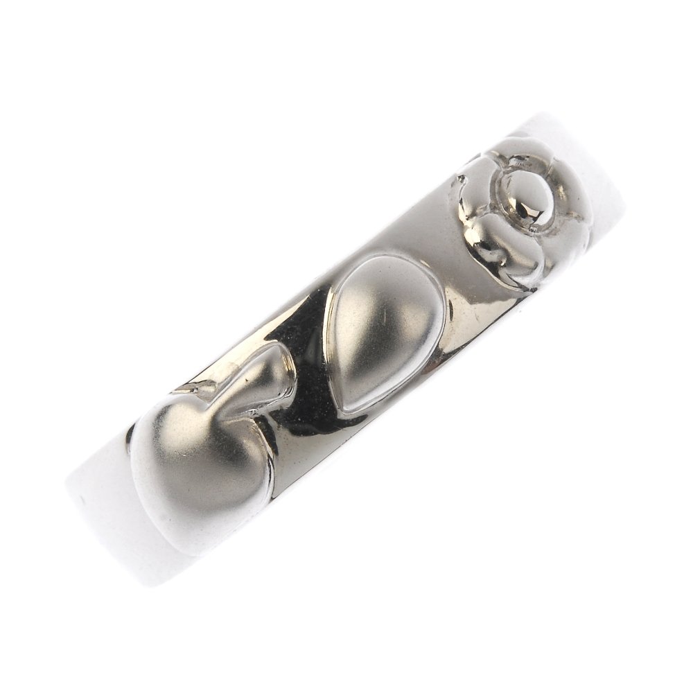 CHIMENTO - an 18ct gold band ring. The stylised floral: CHIMENTO - an 18ct gold band ring. The stylised floral and foliate textured motif, with a polished band. Signed Chimento. Hallmarks for 18ct gold, indistinct. Ring size N. Weight 8.1gms. With maker's