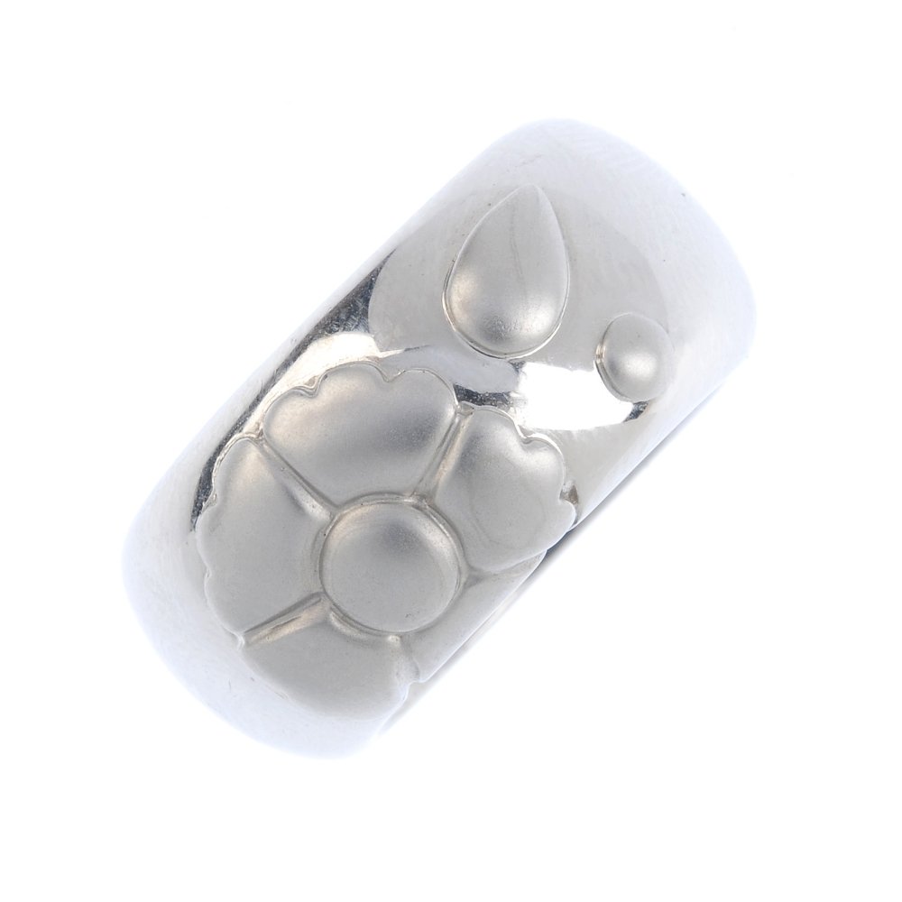 CHIMENTO - an 18ct gold band ring. Designed as a: CHIMENTO - an 18ct gold band ring. Designed as a textured stylised flower, with plain polished band. Signed Chimento. Hallmarks for 18ct gold, partially indistinct. Ring size N. Weight 15.8gms. Overal