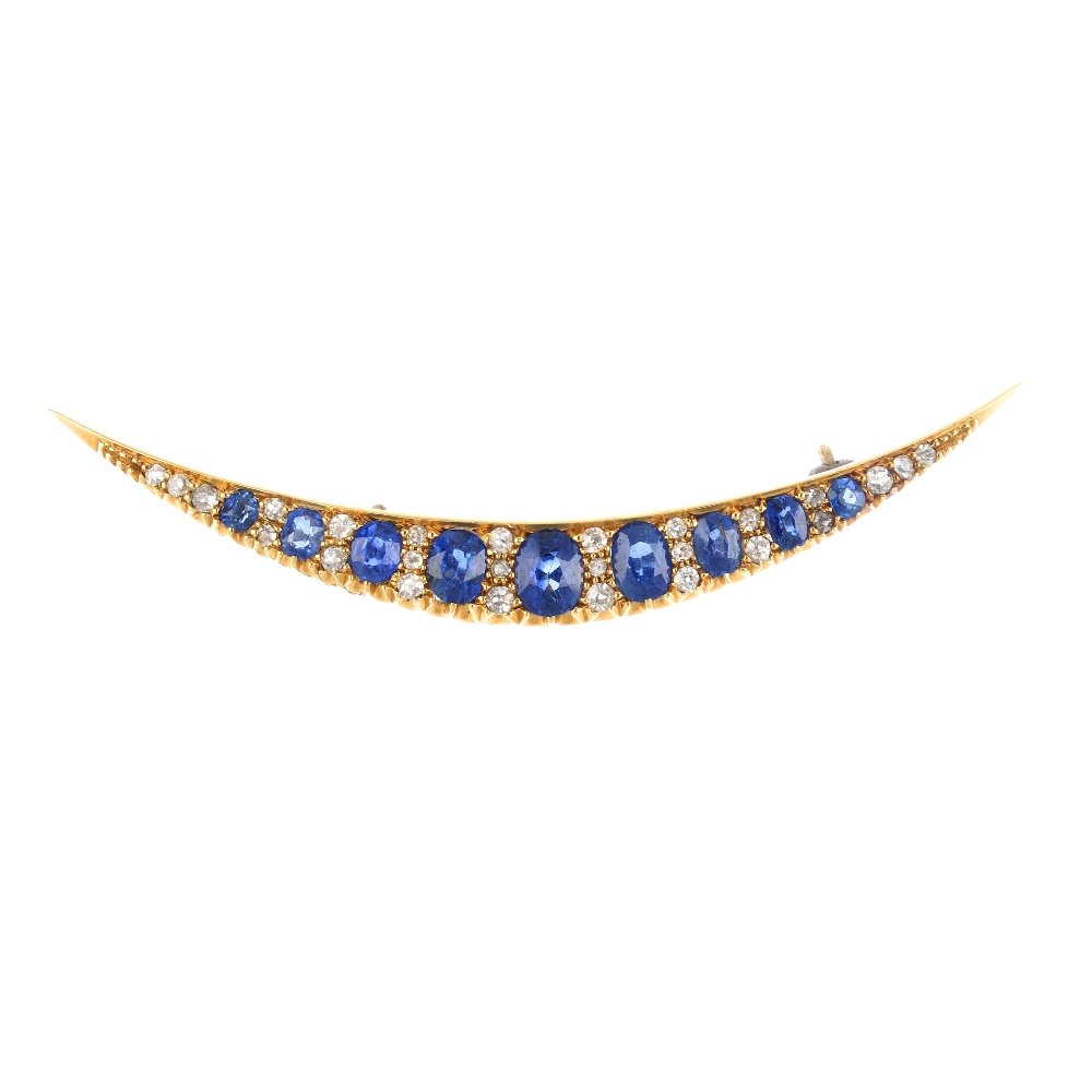 A sapphire and diamond brooch. The graduated oval-shape (1 of 2)