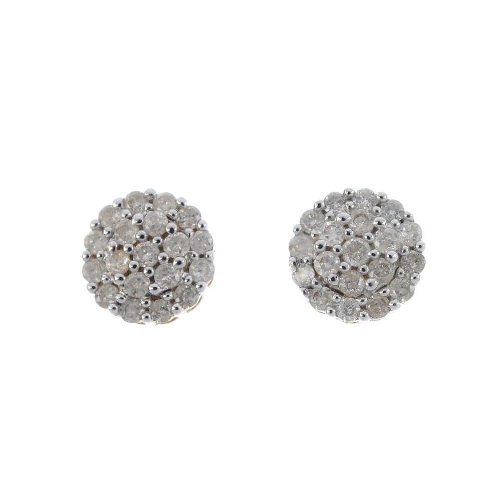 A pair of diamond ear studs. Each designed as a (1 of 2)