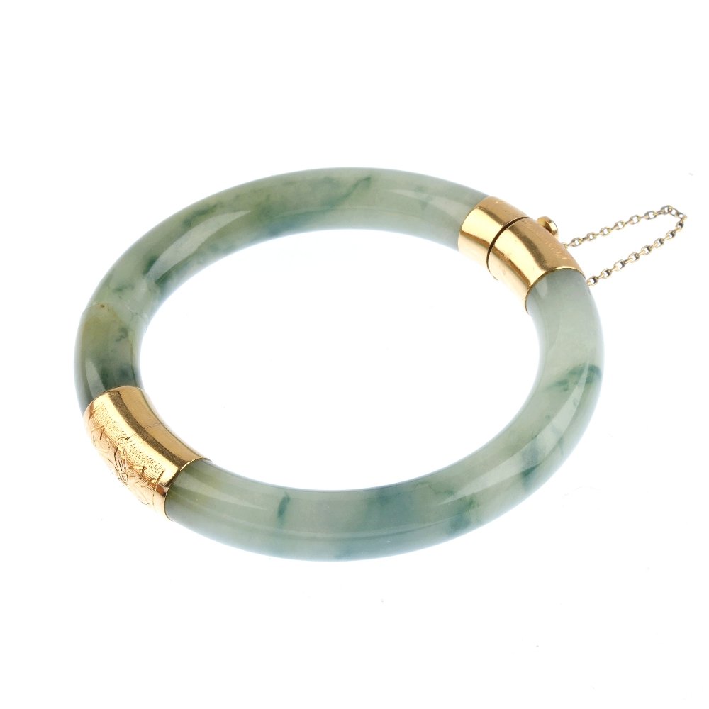 An early 20th century gold jade bangle, AF. The jade (1 of 2)