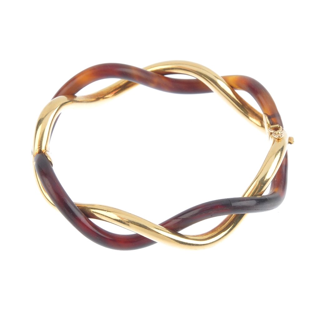 (545050-2-A) An 18ct gold and horn hinged bangle. (1 of 3)