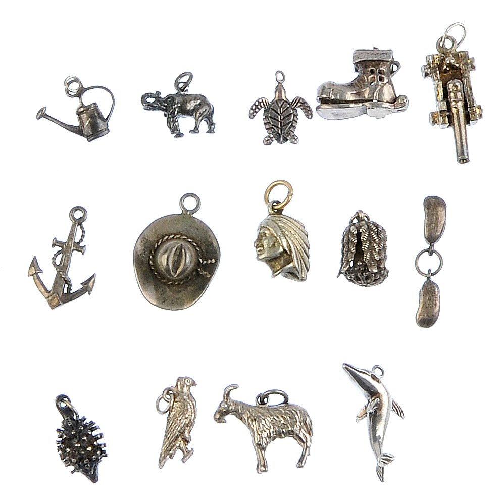 Four charm bracelets and a selection of loose charms.: Four charm bracelets and a selection of loose charms. To include four curb-link bracelets, suspending forty-one charms and a further thirty-six loose charms. Most with marks indicating silver. Length