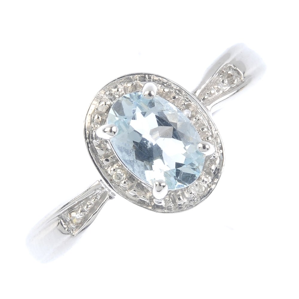 A 9ct gold aquamarine and diamond cluster ring. The (1 of 3)
