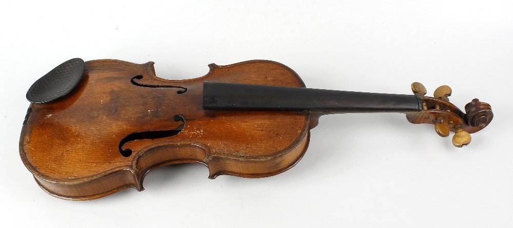 A violin c.1900, probably French, pseudo label detailed: A violin c.1900, probably French, pseudo label detailed 'Petrus Guarnerius Cremonensis fecit Mantua sub tit Sancta Teresia 16', 23.25 (59cm) long, in crocodile skin case. Violin worn, scratched, dente