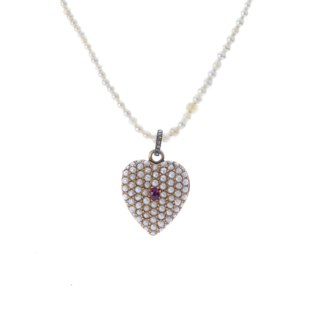 An early 20th century gold ruby and seed pearl locket. (1 of 4)