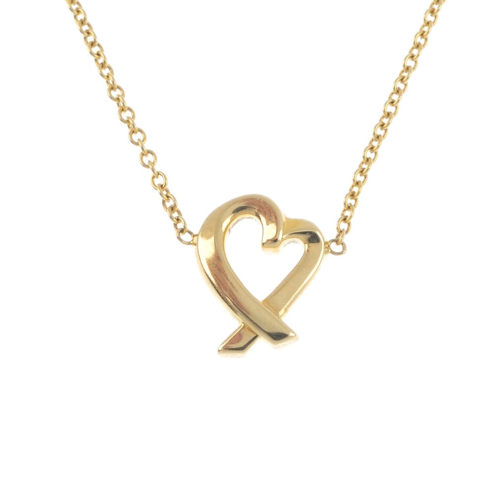 TIFFANY & CO. - A gold 'Loving Heart' pendant. The: TIFFANY & CO. - A gold 'Loving Heart' pendant. The stylised heart, with crossed point, suspended from an integral trace-link chain. Signed Tiffany & Co. Facsimile signature for Paloma Picasso. Length 