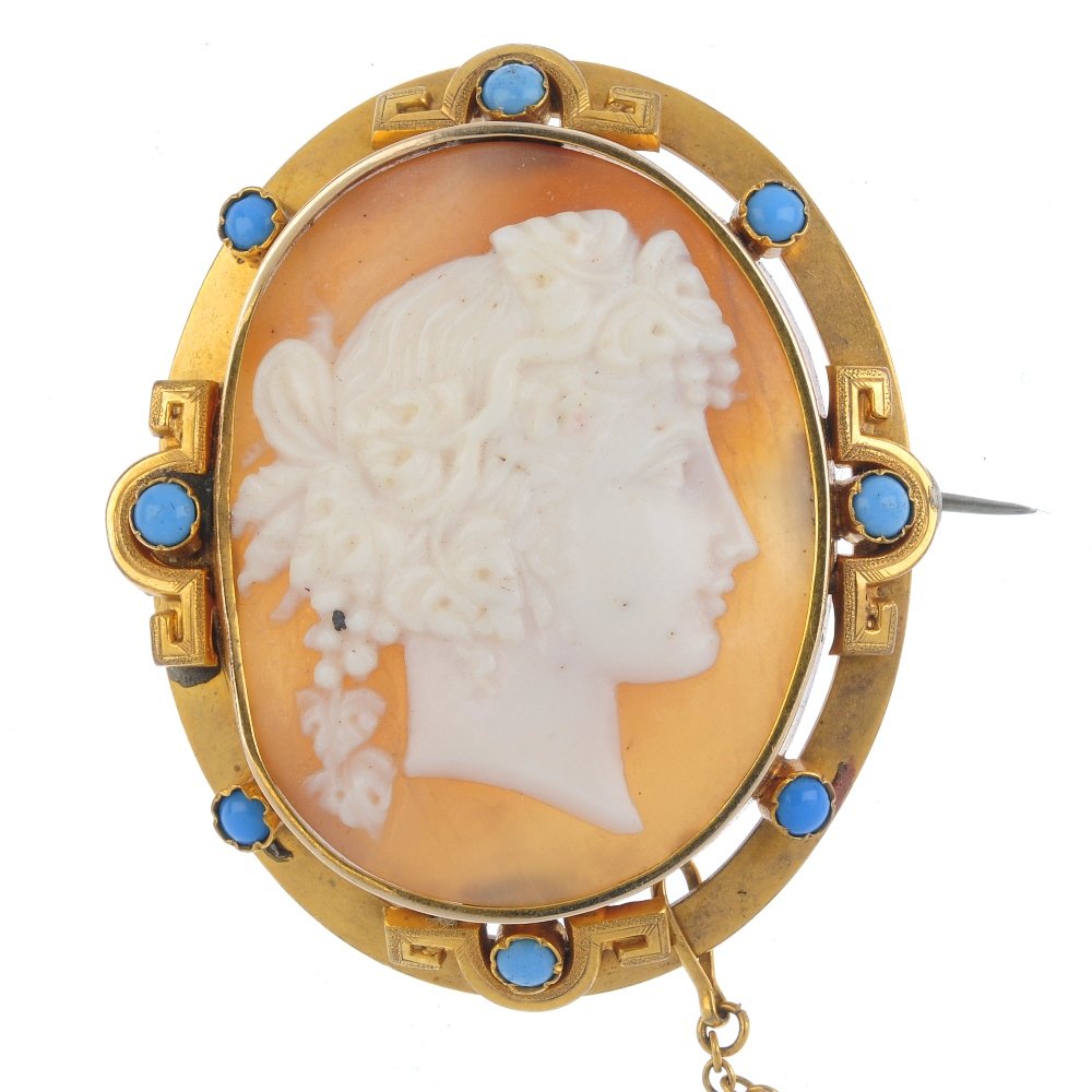 An early 20th century gold shell cameo brooch.: An early 20th century gold shell cameo brooch. Depicting a bacchante, within a blue paste Greek-key border. Length 4.4cms. Weight 11.3gms. Overall condition fair to good. Some surface scratches/ wear,