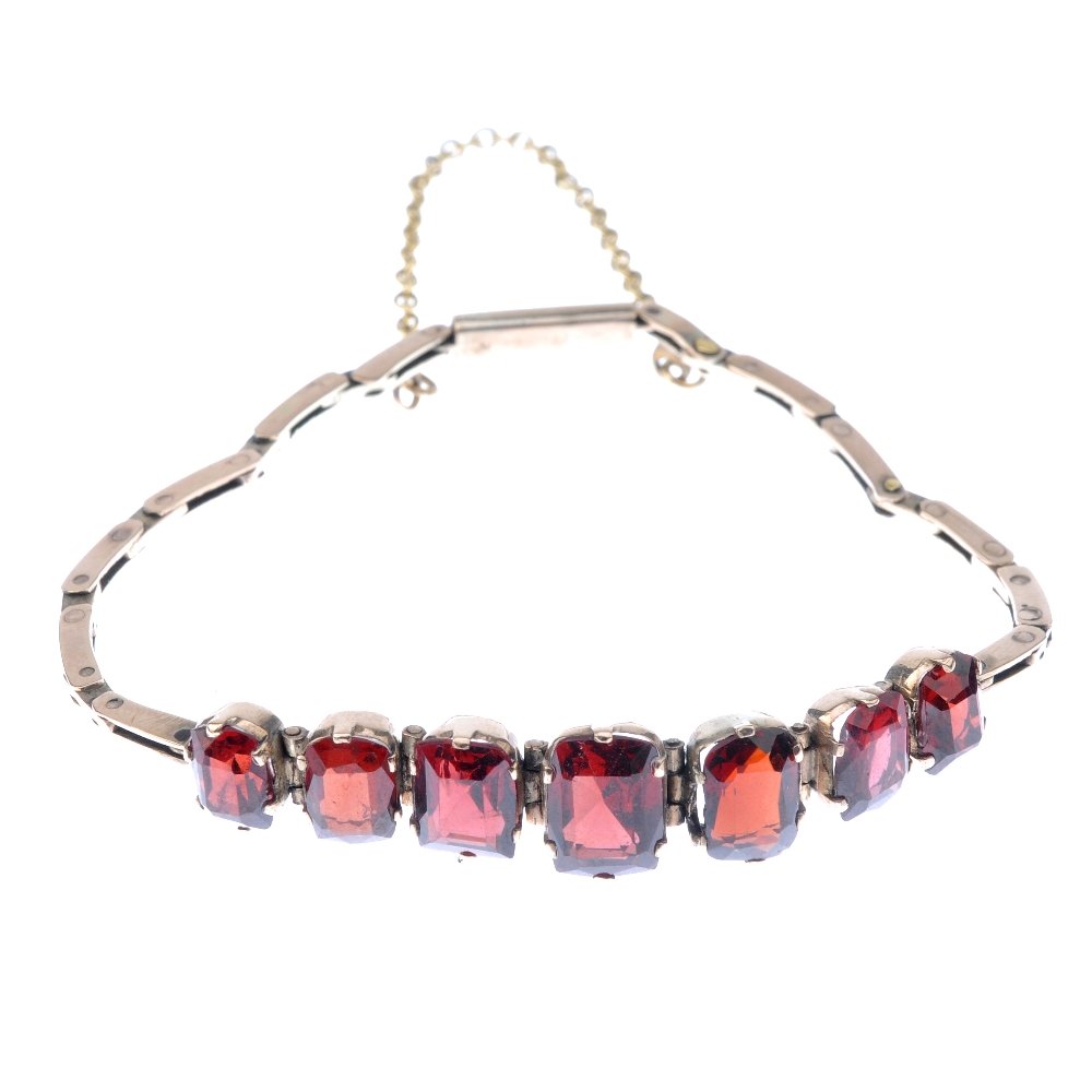 An early 20th century gold garnet bracelet. Designed as (1 of 3)