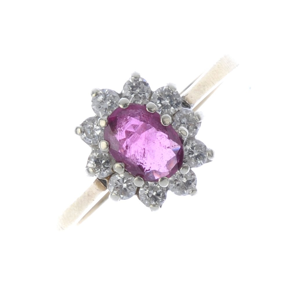 A 9ct gold ruby and diamond cluster ring. The (1 of 3)