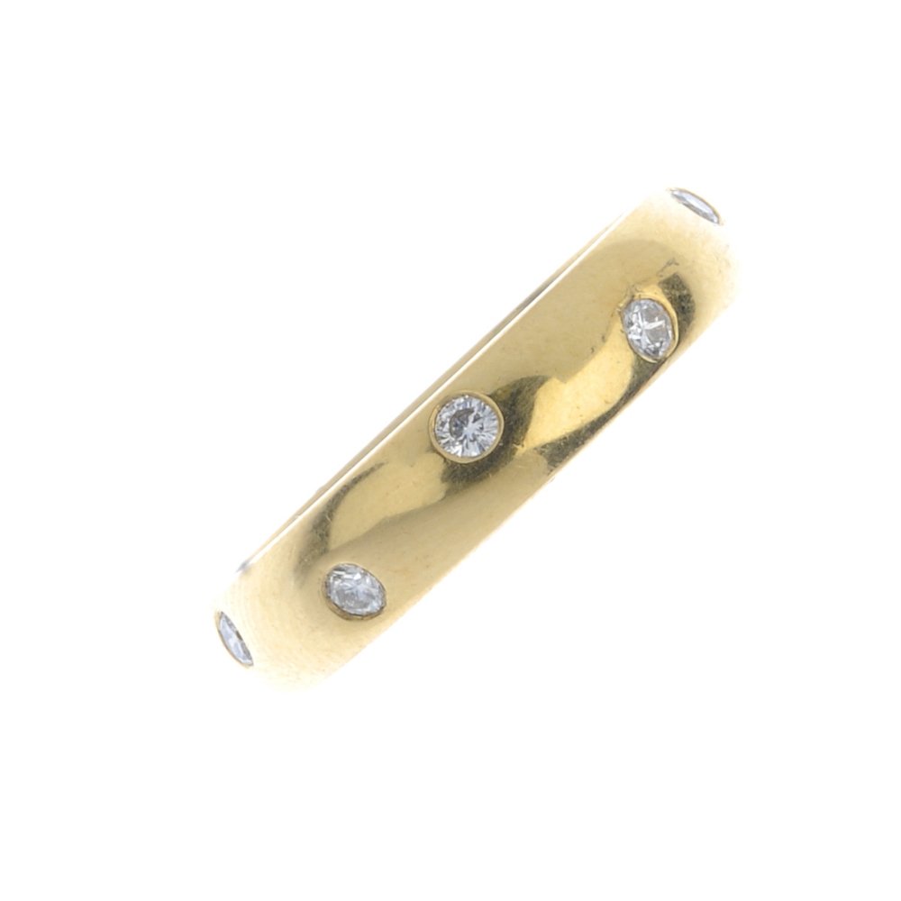 An 18ct gold diamond band ring. The plain band, inset (1 of 3)