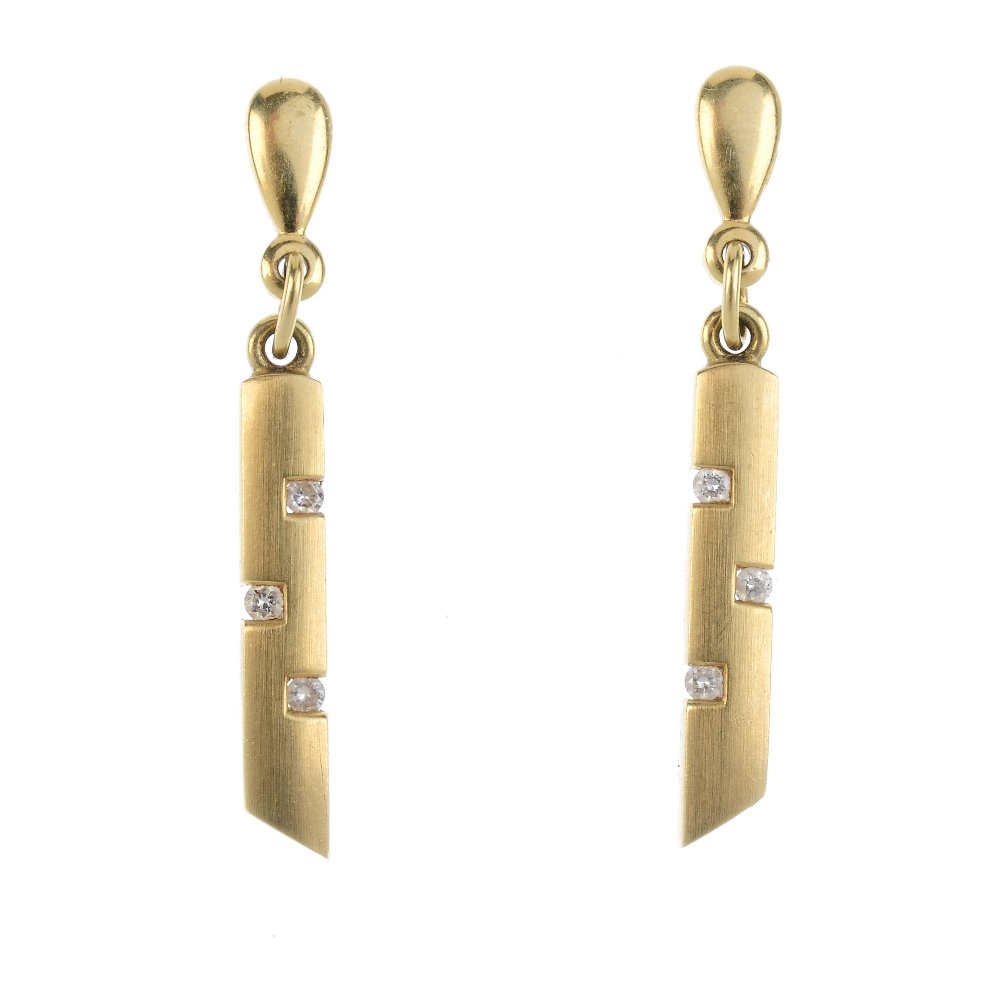 A pair of diamond earrings. Each designed as a: A pair of diamond earrings. Each designed as a brilliant-cut diamond angular line, inset to a polished bar and suspended from a pear-shape surmount. Length 3.2cms. Weight 3.1gms. Overall condition fai