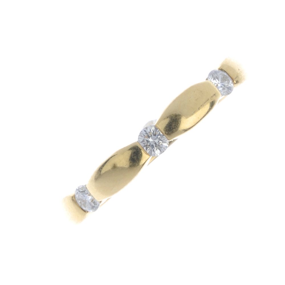 An 18ct gold diamond three-stone band ring. Designed as (1 of 3)
