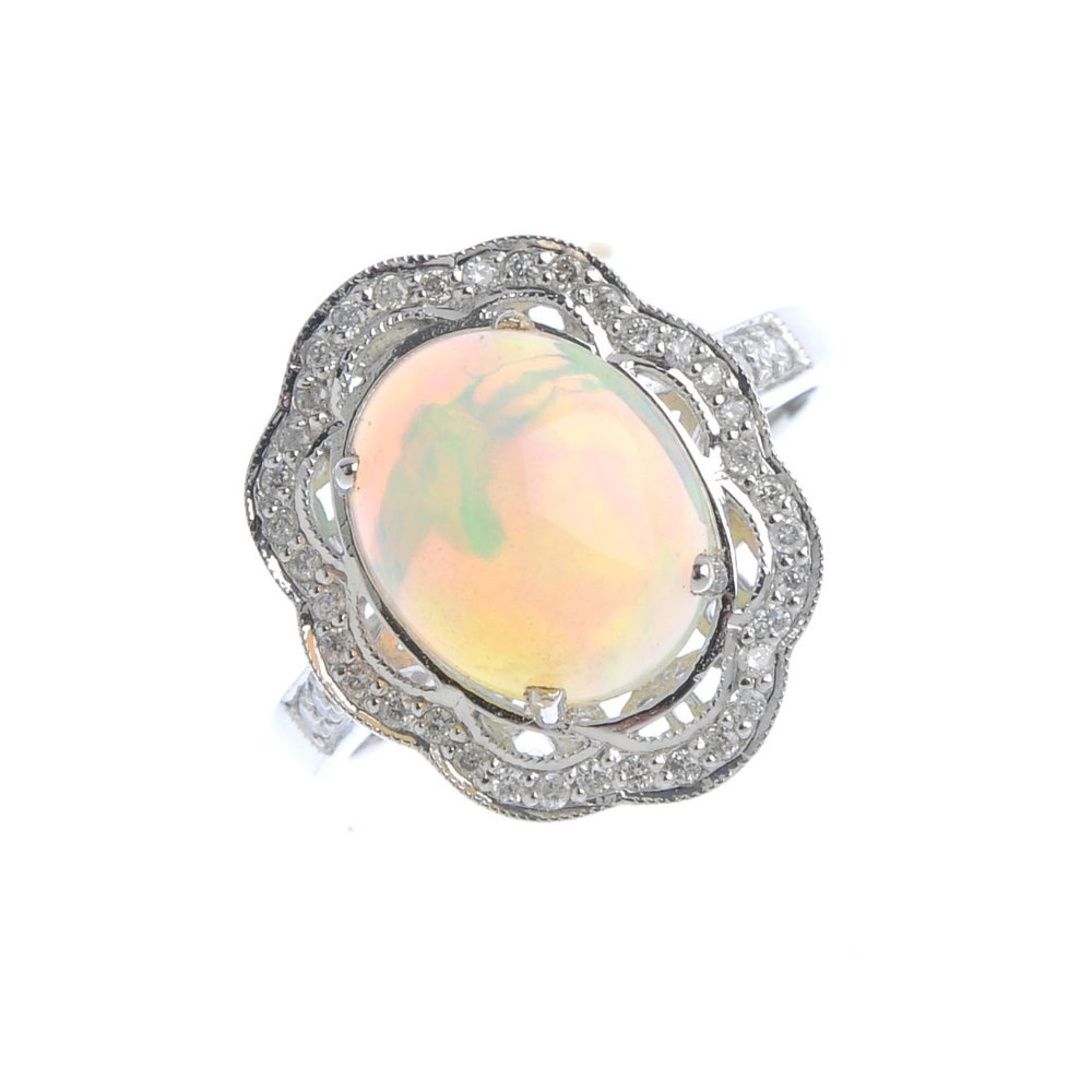 An opal and diamond cluster ring. The oval opal (1 of 3)