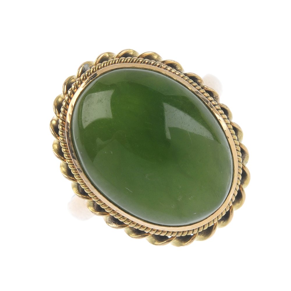 A jade single-stone ring. The oval jade cabochon, (1 of 3)