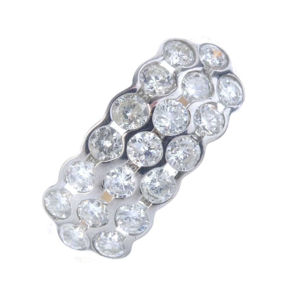 A 9ct gold diamond dress ring. Comprising three (1 of 3)