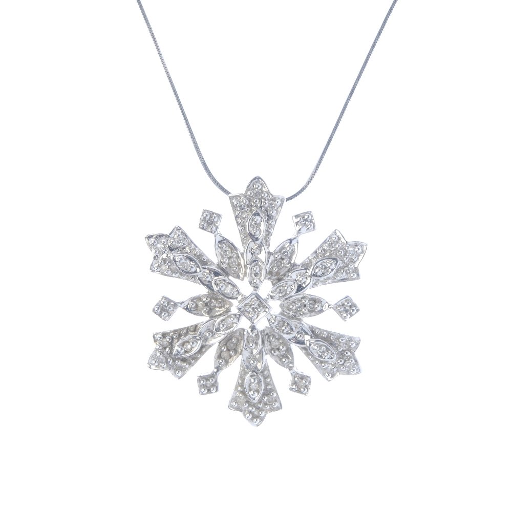 A 9ct gold diamond snowflake pendant. The single-cut (1 of 3)