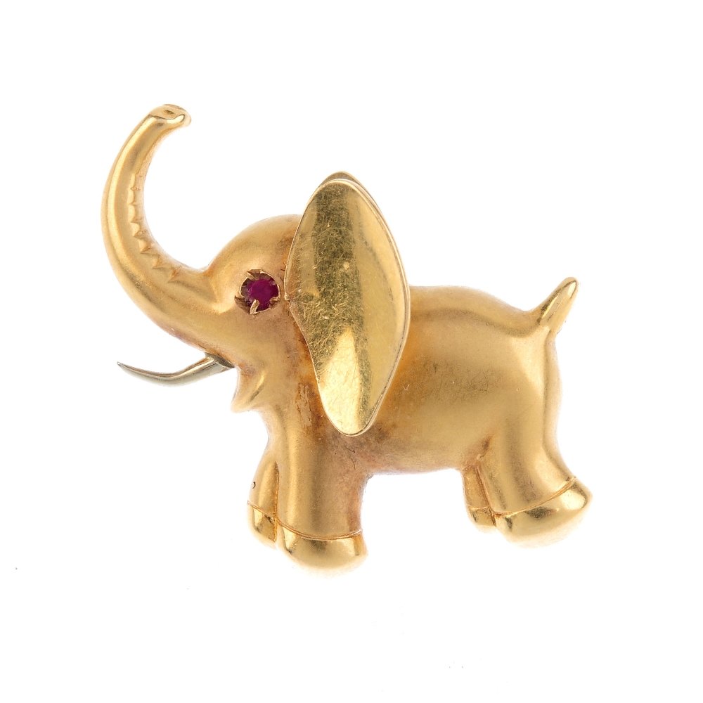 A gem-set elephant brooch. The elephant of plain form, (1 of 2)