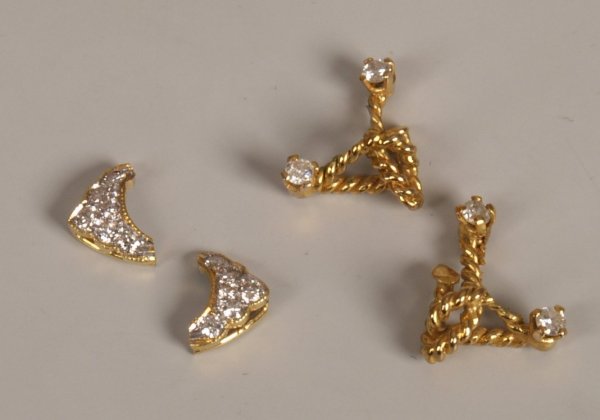 Four pendants to include a diamond knot design pen: Four pendants to include a diamond knot design pendant set two round brilliant diamonds and another of similar design also a curved design diamond pendant set six round brilliant diamonds and another