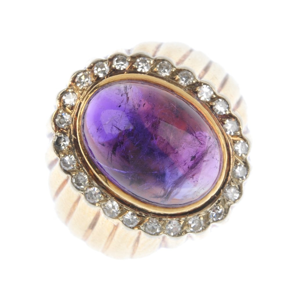 An amethyst and diamond cluster ring. The oval amethyst (1 of 3)