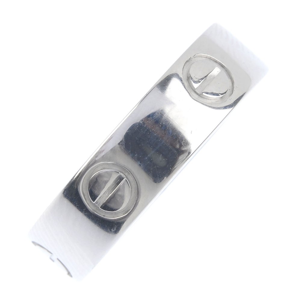 CARTIER - an 18ct gold 'Love' band ring. Decorated with (1 of 3)