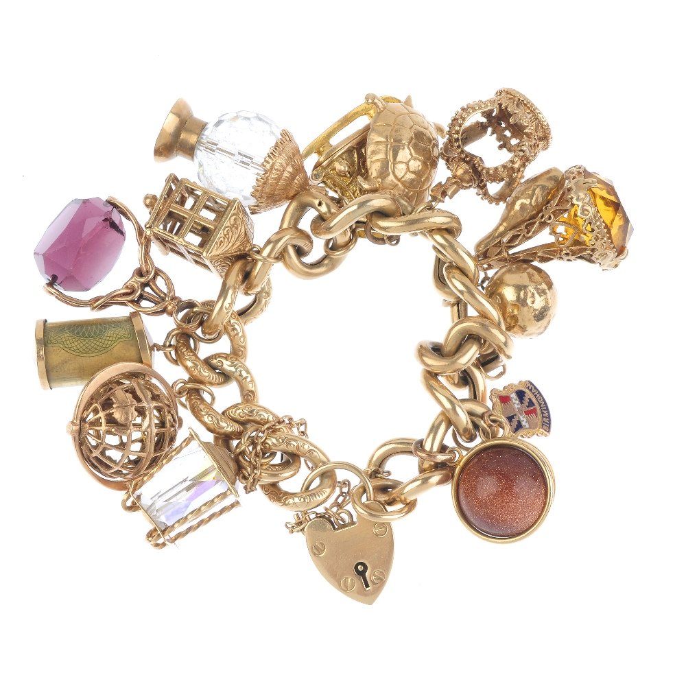 A charm bracelet. The 9ct gold scroll engraved (1 of 2)