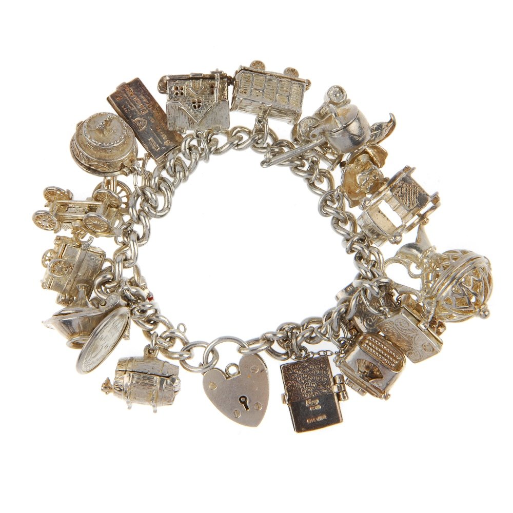 Three charm bracelets. All curb link chain bracelets,: Three charm bracelets. All curb link chain bracelets, suspending a total of seventy-one charms between them, including a bee hive charm, a typewriter charm, a castanets charm and fire engine charm. Ma