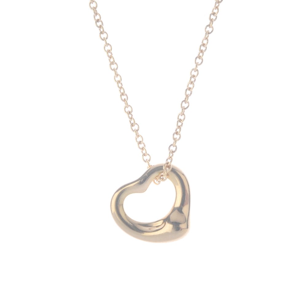 TIFFANY & CO. - an 'Open Heart' pendant by Elsa Peretti: TIFFANY & CO. - an 'Open Heart' pendant by Elsa Peretti for Tiffany & Co. The stylised heart, suspended from a trace-link chain. Signed Tiffany & Co., Peretti. Length of pendant 1cm. Length of chain 4