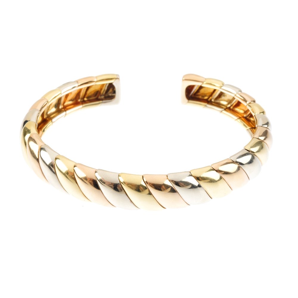 CARTIER - a torque bangle. Of tri-colour design, (1 of 3)